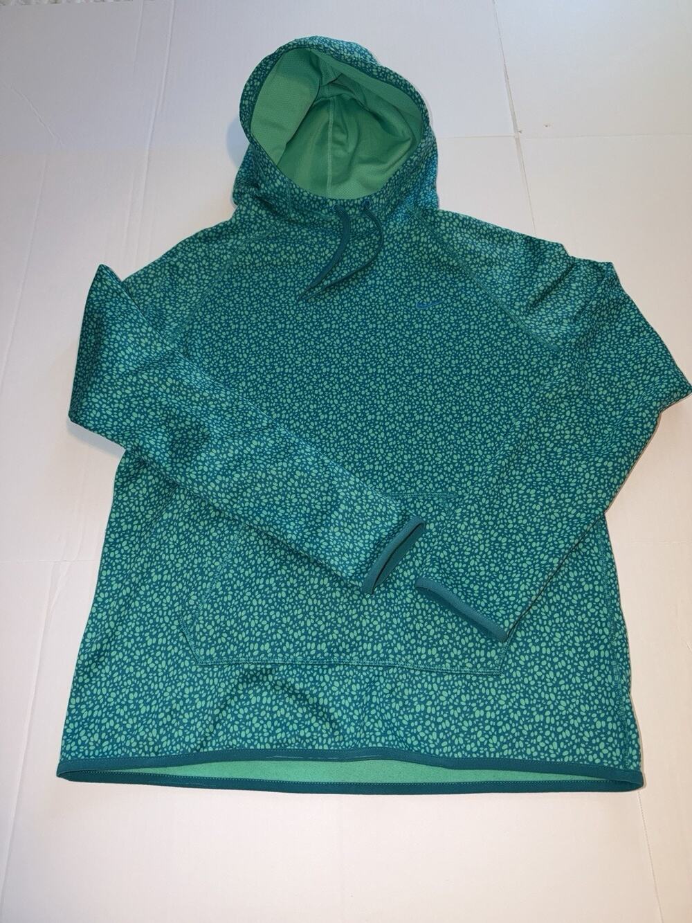 Nike Therma-FIT hoodie features a teal and green all-over pebble pattern